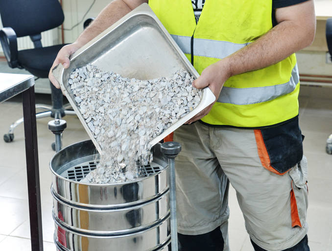 Sifting concrete, part of the aggregate testing process